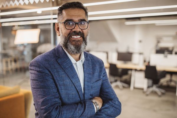 Man In Office Smiling At Camera